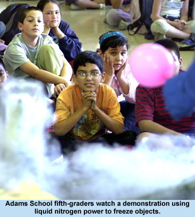Adams School fifth-graders watch a demonstration using liquid nitrogen power to freeze objects.